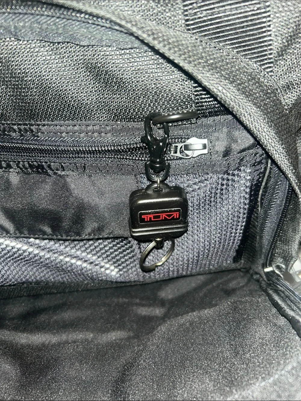 Tumi Black Duffel Bag with Red Logo Accent